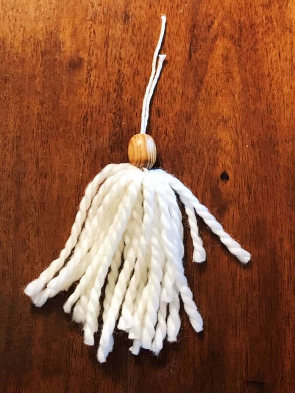 We added a bead on top of our tassels since we're planning to use them as Christmas ornaments.  This is optional of course