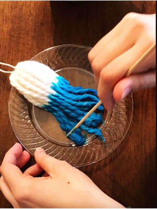 We used a stick to move our tassels around and avoid getting dye on our fingers or clothing