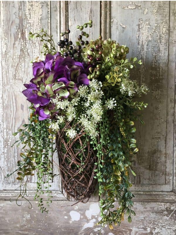 A basket to hang on your front door is a good alternative to a round wreath for spring | WildflowersAndWanderlust.com